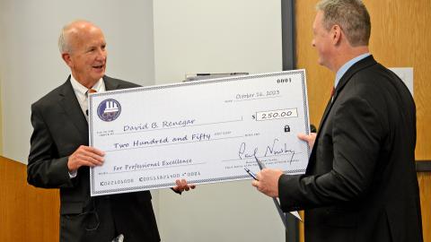 Chief Justice Paul Newby (left) presents NCGAL District Administrator David Renegar (right) with the 2023 Courthouse Employee of they Year Award